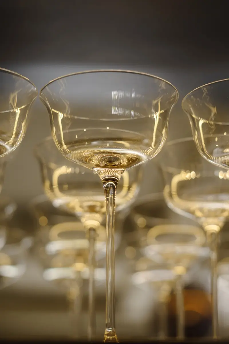 Row of cocktail coupes catching warm light