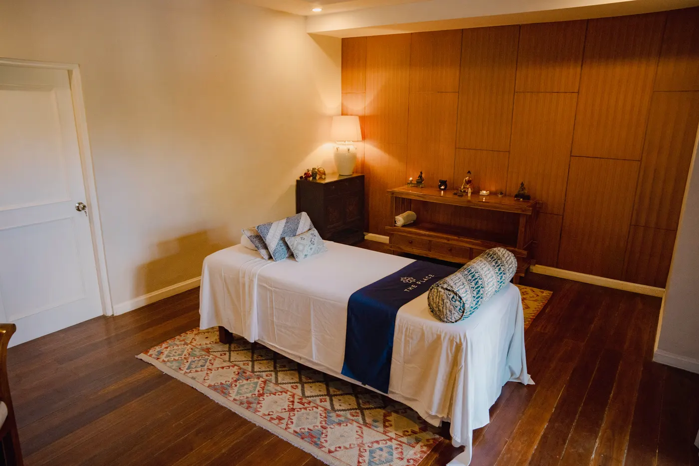Therapy room with a made-up bed and blue cushions
