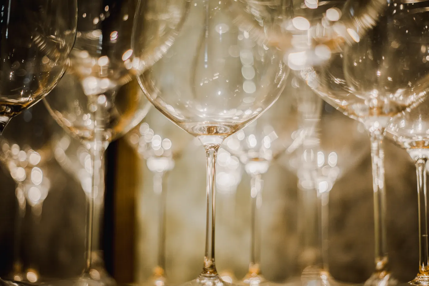 Wine glasses lined up in warm light