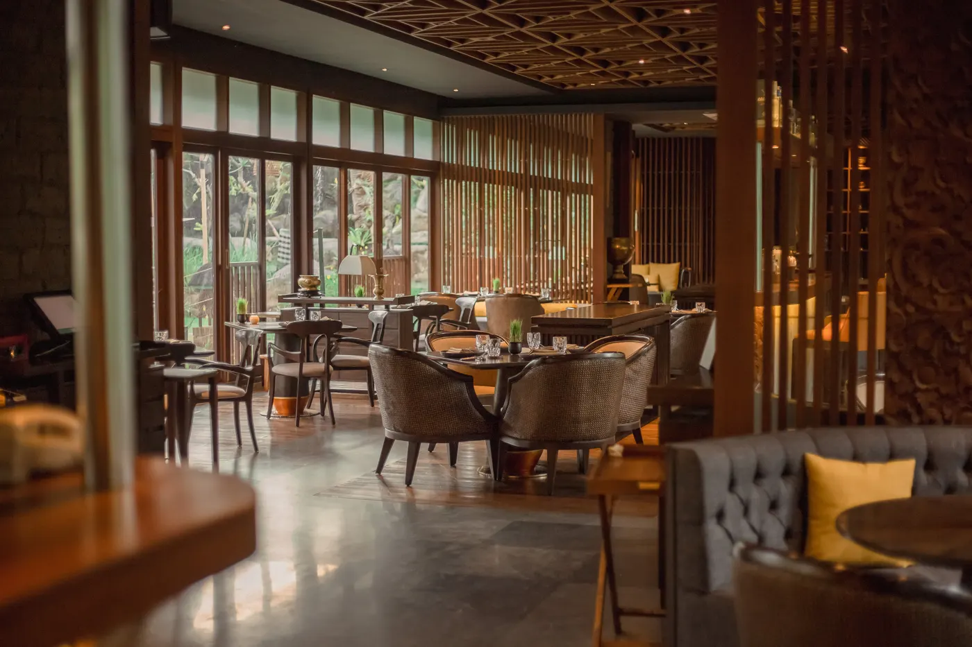Lumbung dining room with timber lattice and soft light