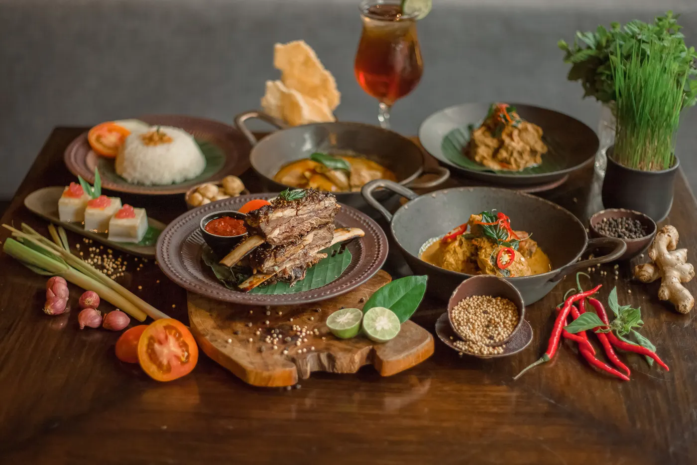 Spread of Balinese dishes with rice and iced tea