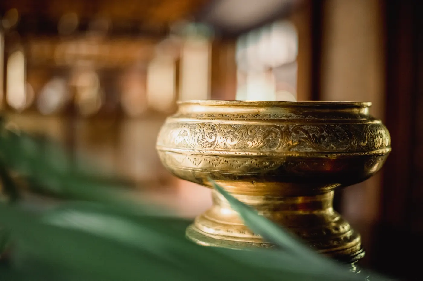 Engraved brass bowl on a green leaf