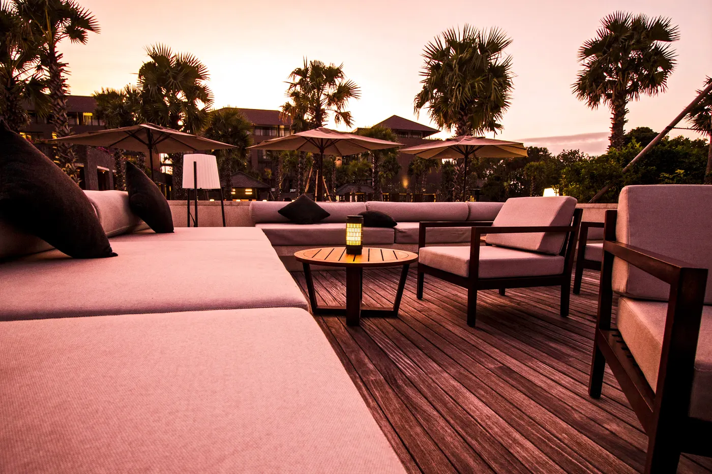 Sunset lounge deck with pink cushions and palms