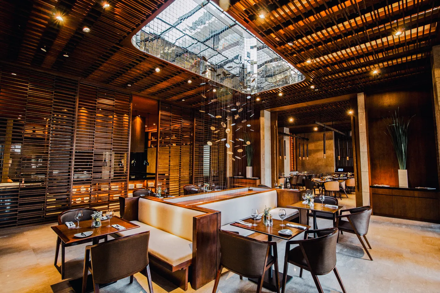 Restaurant under a glass skylight with timber screens