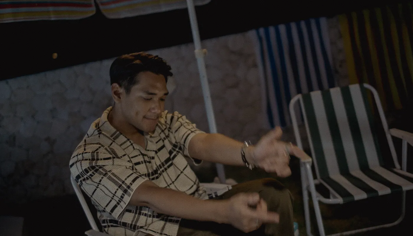 Afgan leaning back at a table at night